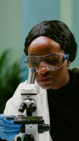 Image of a lady looking through a microscope